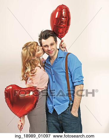 Cute blonde girl kissing her valentine’ s boyfriend View Large Photo Image Stock Photo - Cute blonde girl kissing her valentine’ s boyfriend. Fotosearch