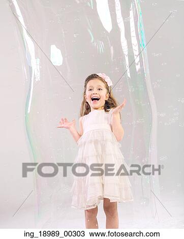 Cute girl in the large soap bubble View Large Photo Image Stock Image - Cute girl in the large soap bubble. Fotosearch