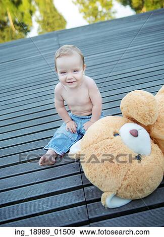 Cute little boy playing teddy bear View Large Photo Image Stock Photo - Cute little boy playing teddy bear. Fotosearch