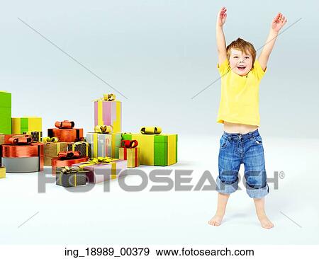 Stock Photo - Cute little boy with lots of presents. Fotosearch