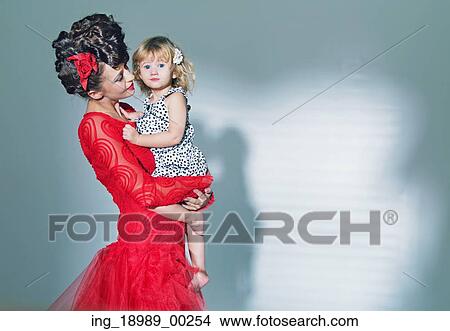 Cute little girl hugged by her elegant mother View Large Photo Image Picture - Cute little girl hugged by her elegant mother. Fotosearch