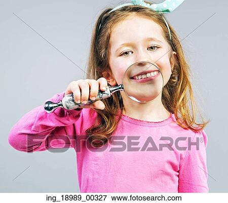 Cute little girl looking through a magnifying glass View Large Photo Image Stock Photo - Cute little girl looking through a magnifying glass. Fotosearch