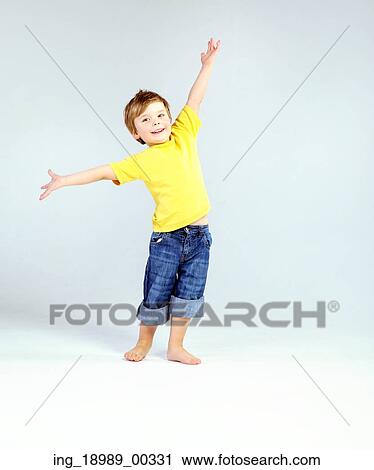 Stock Image - Cute little kid wearing yellow T-shirt. Fotosearch