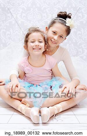 Stock Image - Cute young sisters during ballet rehearsal. Fotosearch