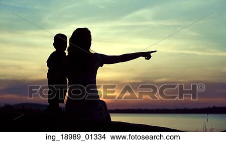 Dark silhouettes of the mother with kid View Large Photo Image Picture - Dark silhouettes of the mother with kid. Fotosearch