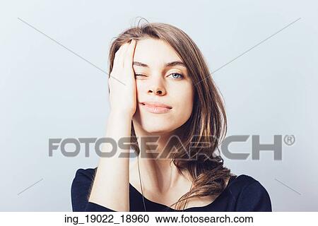 Stock Image - depressed girl on a gray background. Fotosearch