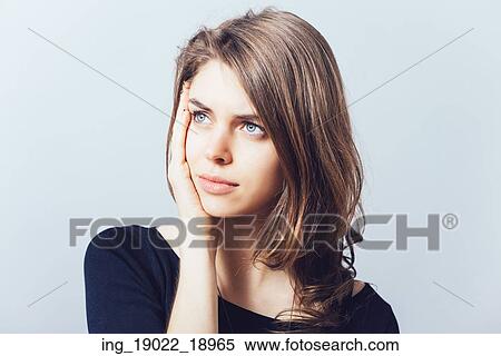 Stock Photography - depressed girl on a gray background. Fotosearch