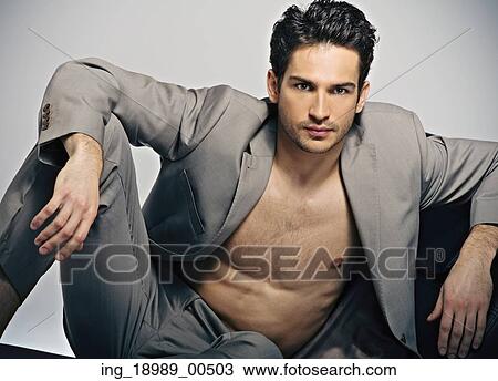 Stock Image - Elegant muscular guy in fashion pose. Fotosearch
