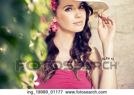 Elegant woman wearing a straw hat View Large Photo Image Stock Photo - Elegant woman wearing a straw hat. Fotosearch