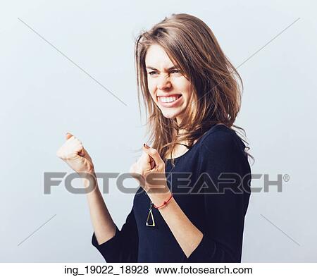 Excited young woman with fists up View Large Photo Image Stock Photo - Excited young woman with fists up. Fotosearch