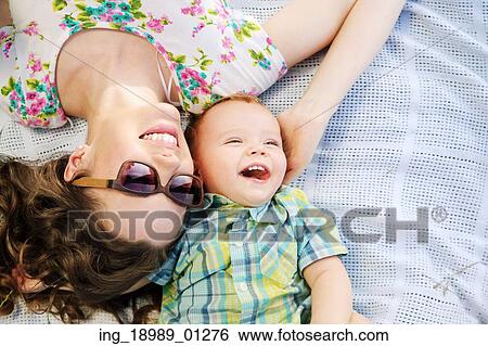 Stock Photograph - Fabulous mother and her cute laughing son. Fotosearch