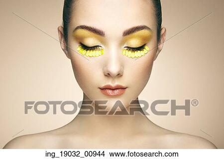 Picture - Face of beautiful woman decorated with flowers. Perfect makeup. Beauty fashion. Eyelashes. Cosmetic Eyeshadow. Fotosearch