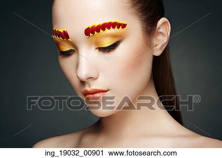Stock Image - Face of beautiful woman decorated with flowers. Perfect makeup. Beauty fashion. Eyelashes. Cosmetic Eyeshadow. Fotosearch