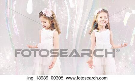 Stock Photography - Fancy picture of little girls closed in large soap bubbles. Fotosearch