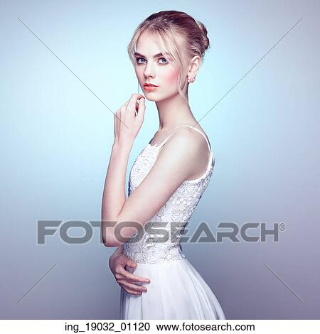 Fashion portrait of beautiful young woman with blond hair. Girl in white dress on white background View Large Photo Image Stock Image - Fashion portrait of beautiful young woman with blond hair. Girl in white dress on white background. Fotosearch