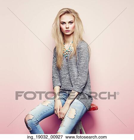 Fashion portrait of beautiful young woman with blond hair. Girl in blouse and jeans. Jewelry and hairstyle View Large Photo Image Stock Photo - Fashion portrait of beautiful young woman with blond hair. Girl in blouse and jeans. Jewelry and hairstyle. Fotosearch
