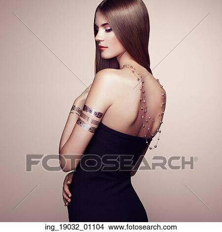 Picture - Fashion portrait of elegant woman with magnificent hair. Blonde girl. Perfect make-up. Girl in elegant dress. Flash tattoo gold. Fotosearch