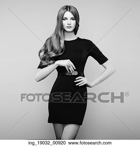 Stock Image - Fashion portrait of elegant woman with magnificent hair. Blonde girl. Perfect make-up. Black and white. Fotosearch