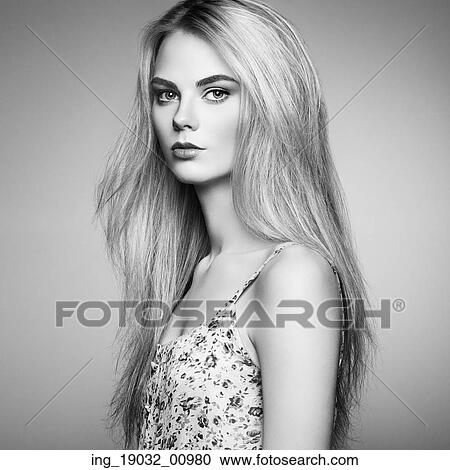 Stock Image - Fashion portrait of elegant woman with magnificent hair. Blonde girl. Perfect make-up. Hairstyle. Fotosearch