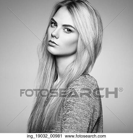 Stock Image - Fashion portrait of elegant woman with magnificent hair. Blonde girl. Perfect make-up. Hairstyle. Fotosearch