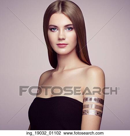 Fashion portrait of elegant woman with magnificent hair. Blonde girl. Perfect make-up. Girl in elegant dress. Flash tattoo gold View Large Photo Image Stock Image - Fashion portrait of elegant woman with magnificent hair. Blonde girl. Perfect make-up. Girl in elegant dress. Flash tattoo gold. Fotosearch