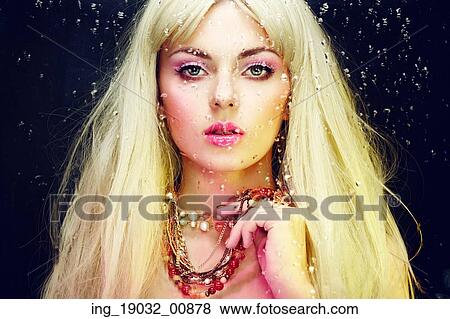Stock Photo - Fashion portrait of elegant woman with magnificent hair. Blonde girl. Jewelry. Perfect make-up. Fotosearch