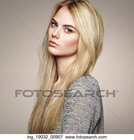 Stock Photo - Fashion portrait of elegant woman with magnificent hair. Blonde girl. Perfect make-up. Hairstyle. Fotosearch