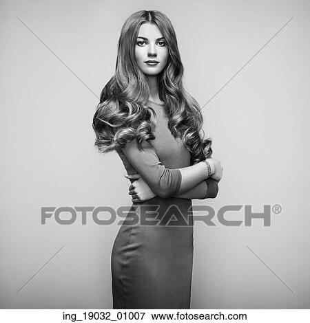 Stock Photo - Fashion portrait of elegant woman with magnificent hair. Blonde girl. Perfect make-up. Girl in elegant dress. Fotosearch