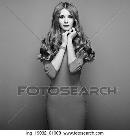 Stock Photo - Fashion portrait of elegant woman with magnificent hair. Blonde girl. Perfect make-up. Girl in elegant dress. Fotosearch