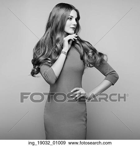 Stock Photo - Fashion portrait of elegant woman with magnificent hair. Blonde girl. Perfect make-up. Girl in elegant dress. Fotosearch