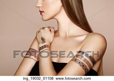 Fashion portrait of elegant woman with magnificent hair. Blonde girl. Perfect make-up. Girl in elegant dress. Flash tattoo gold View Large Photo Image Stock Photo - Fashion portrait of elegant woman with magnificent hair. Blonde girl. Perfect make-up. Girl in elegant dress. Flash tattoo gold. Fotosearch