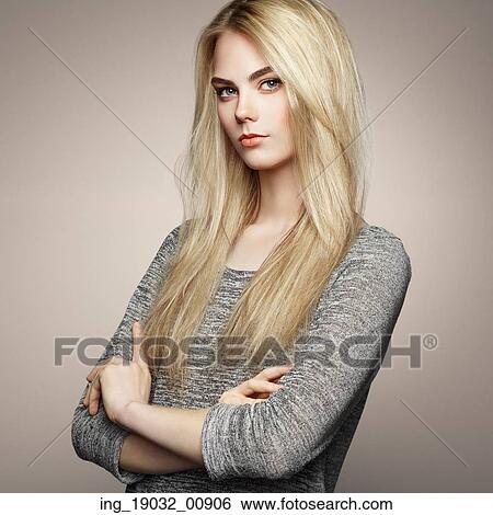 Stock Photograph - Fashion portrait of elegant woman with magnificent hair. Blonde girl. Perfect make-up. Hairstyle. Fotosearch