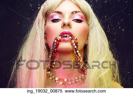 Stock Photography - Fashion portrait of elegant woman with magnificent hair. Blonde girl. Jewelry. Perfect make-up. Fotosearch