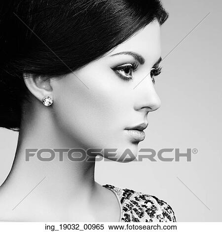 Stock Photography - Fashion portrait of elegant woman with magnificent hair. Brunette girl. Perfect make-up. Fotosearch