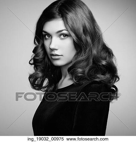 Fashion portrait of elegant woman with magnificent hair. Brunette girl. Perfect make-up. Girl in black dress. Curly hair View Large Photo Image Stock Photography - Fashion portrait of elegant woman with magnificent hair. Brunette girl. Perfect make-up. Girl in black dress. Curly hair. Fotosearch
