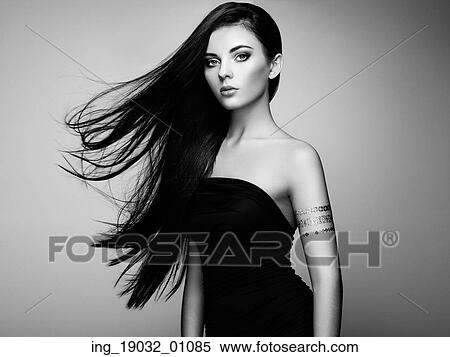 Fashion portrait of elegant woman with magnificent hair. Brunette girl. Perfect make-up. Girl in elegant dress. Flash tattoo gold. Black and white View Large Photo Image Stock Photography - Fashion portrait of elegant woman with magnificent hair. Brunette girl. Perfect make-up. Girl in elegant dress. Flash tattoo gold. Black and white. Fotosearch