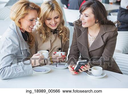Stock Photograph - Female friends at the cofee break. Fotosearch