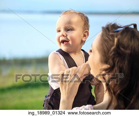 Fine photo of the woman carrying the baby View Large Photo Image Picture - Fine photo of the woman carrying the baby. Fotosearch