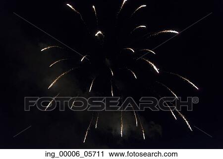 Stock Image - Fireworks display at night on Canada Day, Kenora, Lake Of The Woods, Ontario, Canada. Fotosearch