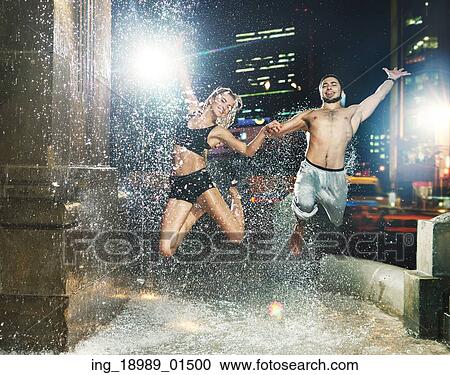 Fit couple jumping in the huge fountain View Large Photo Image Stock Image - Fit couple jumping in the huge fountain. Fotosearch