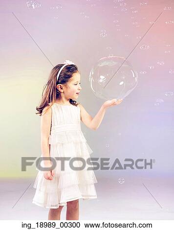 Funny lovely little woman playing with soap bubbles View Large Photo Image Stock Image - Funny lovely little woman playing with soap bubbles. Fotosearch