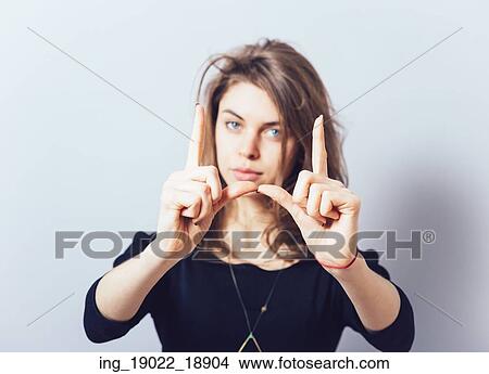 Picture - girl doing hand frame. Fotosearch