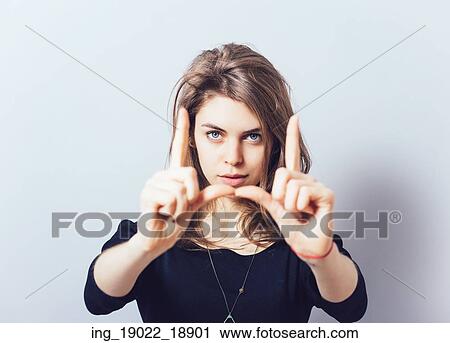 Stock Image - girl doing hand frame. Fotosearch