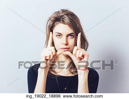 Stock Photo - girl doing hand frame. Fotosearch