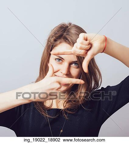 Stock Image - girl makes a frame arms. Fotosearch