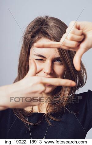 Stock Image - girl makes a frame arms. Fotosearch