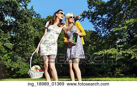 Girlfriends looking for field for picnic View Large Photo Image Stock Photo - Girlfriends looking for field for picnic. Fotosearch