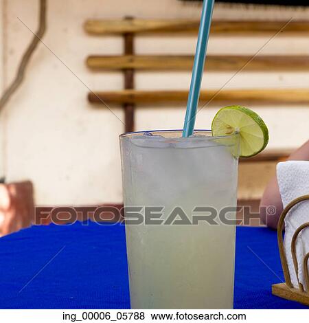 Stock Photo - Glass of lemonade with a straw, Ixtapa, Zihuatanejo, Guerrero, Mexico. Fotosearch