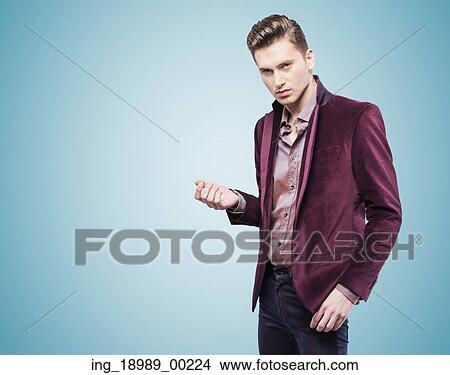 Picture - Handsome young businessman over the blue background. Fotosearch