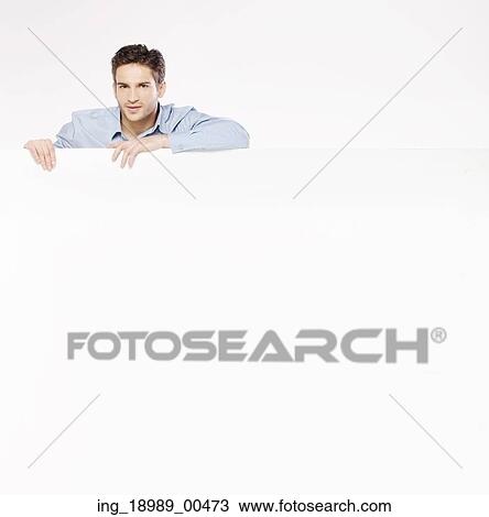 Handsome young gentleman with huge empty board View Large Photo Image Stock Image - Handsome young gentleman with huge empty board. Fotosearch